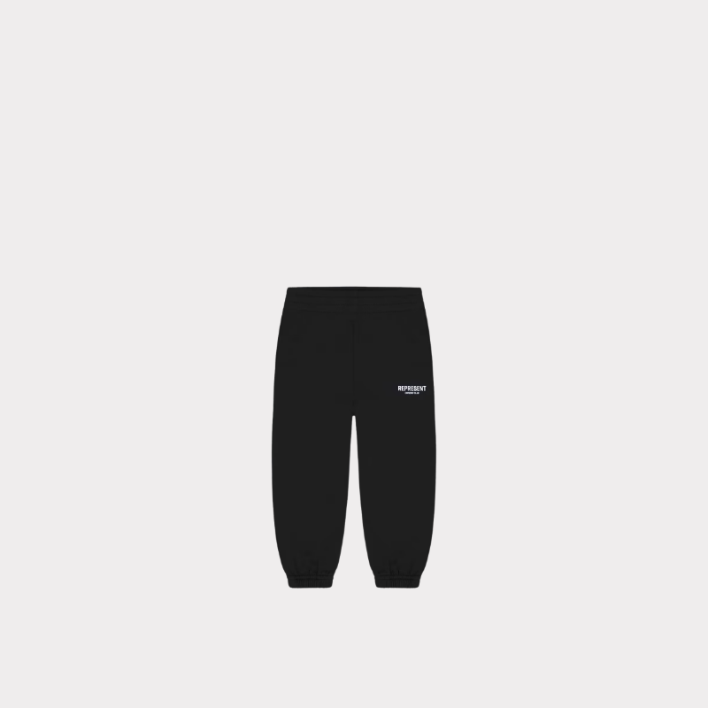 Front view of black parachute pants showing the relaxed shape and everyday streetwear design. Description: Front view of black parac Black parachute pants front view showing the relaxed fit and overall leg shape.